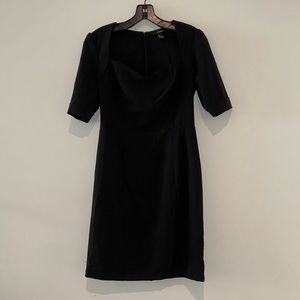 Black Dress w/ short sleeves and slight sweetheart neckline, hits above knee